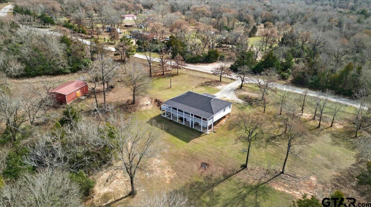 2375 County Road 3282 Buffalo, TX 75831 - Photo 42 of 48 an aerial view of a house with swimming pool and large trees
