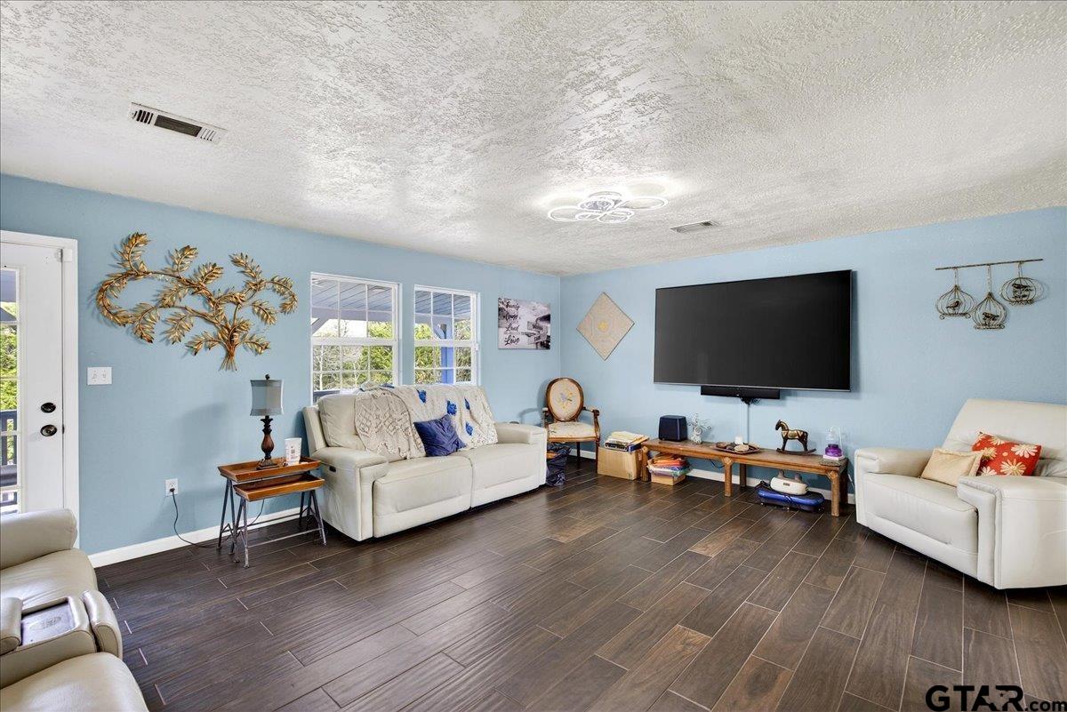 2375 County Road 3282 Buffalo, TX 75831 - Photo 10 of 48 a living room with furniture and a flat screen tv