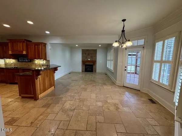 a view of kitchen with kitchen island stainless steel appliances refrigerator sink and cabinets