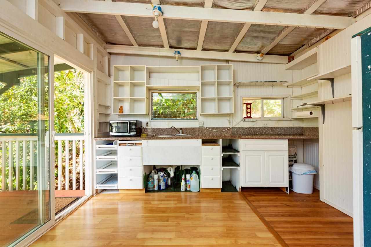 2665 Kaupakalua Road Haiku, HI 96708 - Photo 9 of 25 a view of an empty room with a fireplace and a window