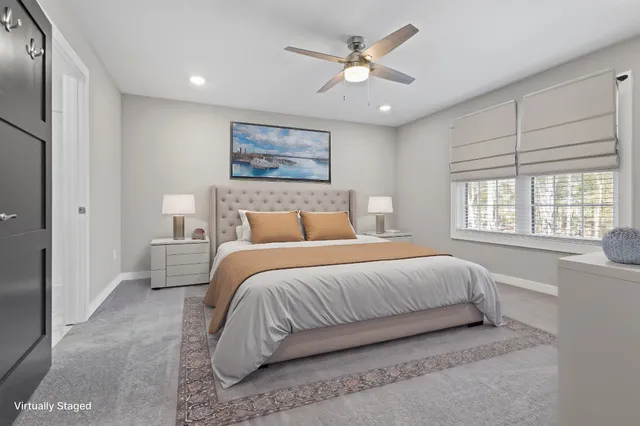 a bedroom with a large bed and a window