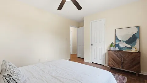 a bedroom with a bed and a painting on the wall
