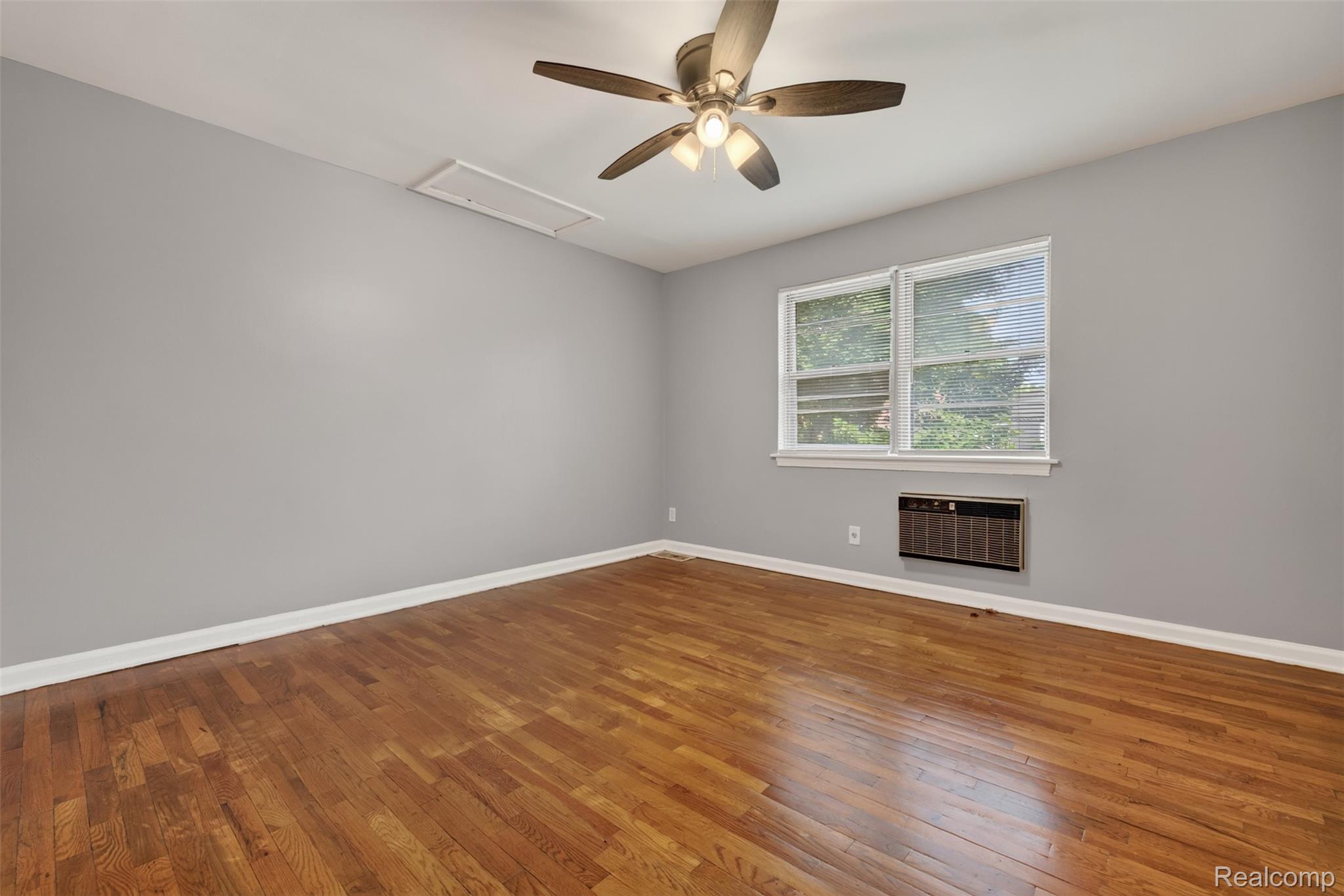 316 Sheffield Avenue Flint, MI 48503 - Photo 19 of 37 Hardwood flooring, light gray wall finish, white trim, ceiling-mounted fan with light fixture, and window with blinds