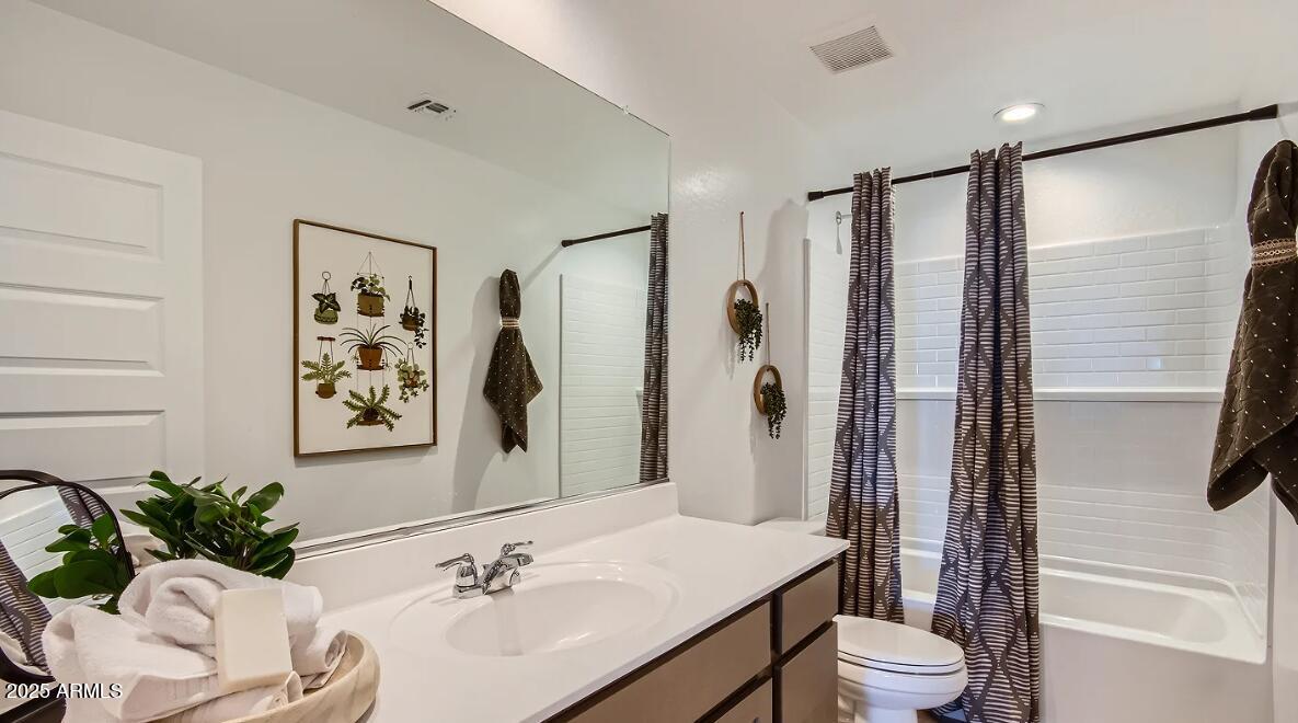 9517 West Cheery Lynn Road Phoenix, AZ 85392 - Photo 16 of 27 a bathroom with a sink toilet and shower