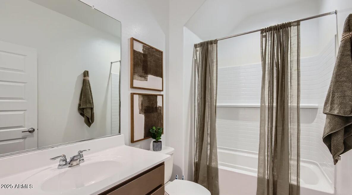 9517 West Cheery Lynn Road Phoenix, AZ 85392 - Photo 18 of 27 a bathroom with a sink and mirror with toilet
