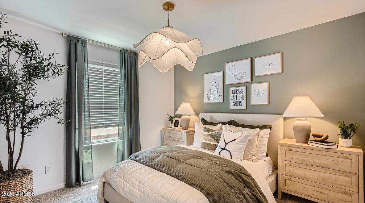 9517 West Cheery Lynn Road Phoenix, AZ 85392 - Photo 19 of 27 a bedroom with a bed and a chandelier