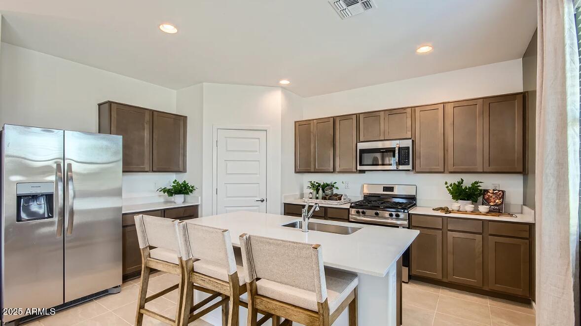 9517 West Cheery Lynn Road Phoenix, AZ 85392 - Photo 3 of 27 a kitchen with a sink cabinets and stainless steel appliances