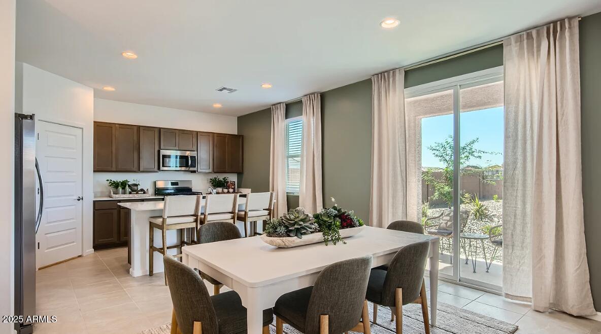9517 West Cheery Lynn Road Phoenix, AZ 85392 - Photo 4 of 27 a view of a dining room with furniture window and wooden floor
