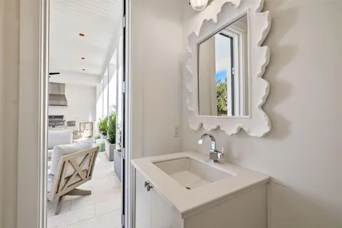 a large bedroom with a bed and a flat tv screen on the dresser