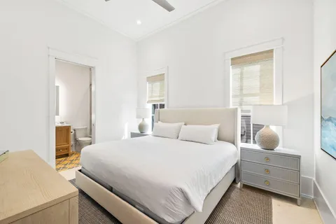 a bedroom with a bed and a potted plant