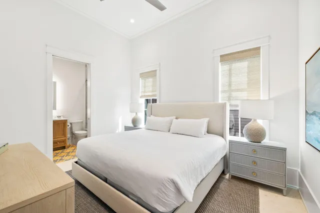 a bedroom with a bed and a potted plant