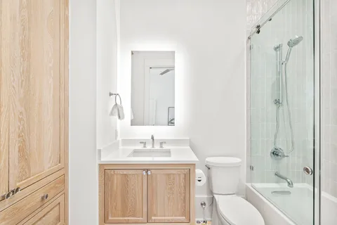 a bathroom with a sink vanity and a toilet