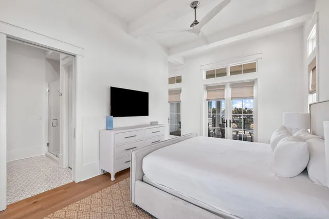 a spacious bedroom with a bed and a flat screen tv