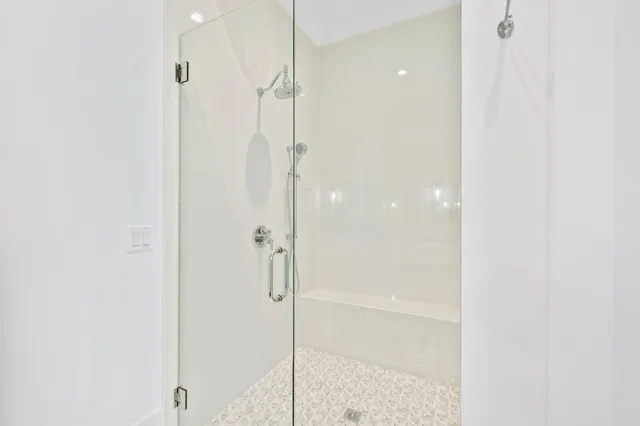 a bathroom with a glass shower door
