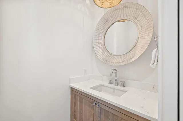 a kitchen with stainless steel appliances granite countertop a sink a stove and a wooden floors