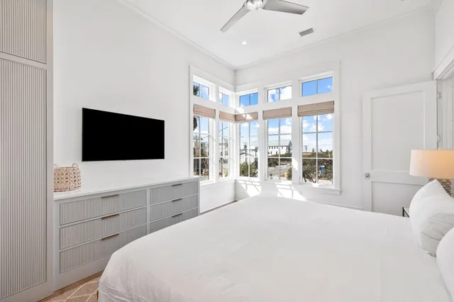 a kitchen with stainless steel appliances granite countertop a stove top oven a sink dishwasher and white cabinets with wooden floor