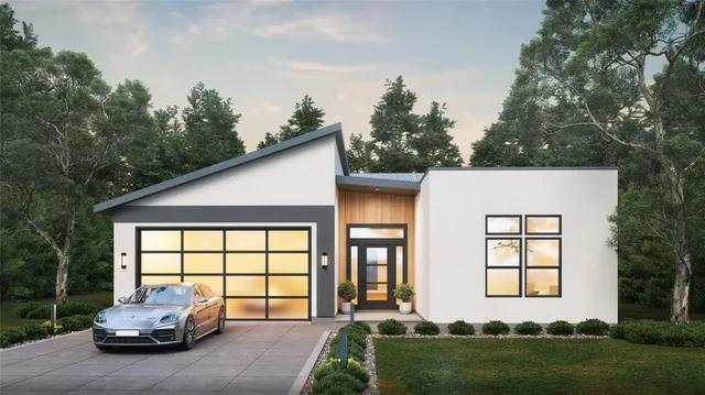 a front view of a house with a garden and plants