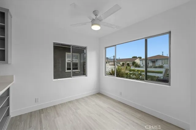 an empty room with windows and closet
