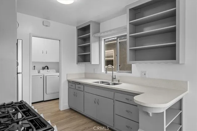 a kitchen with a sink stove and cabinets