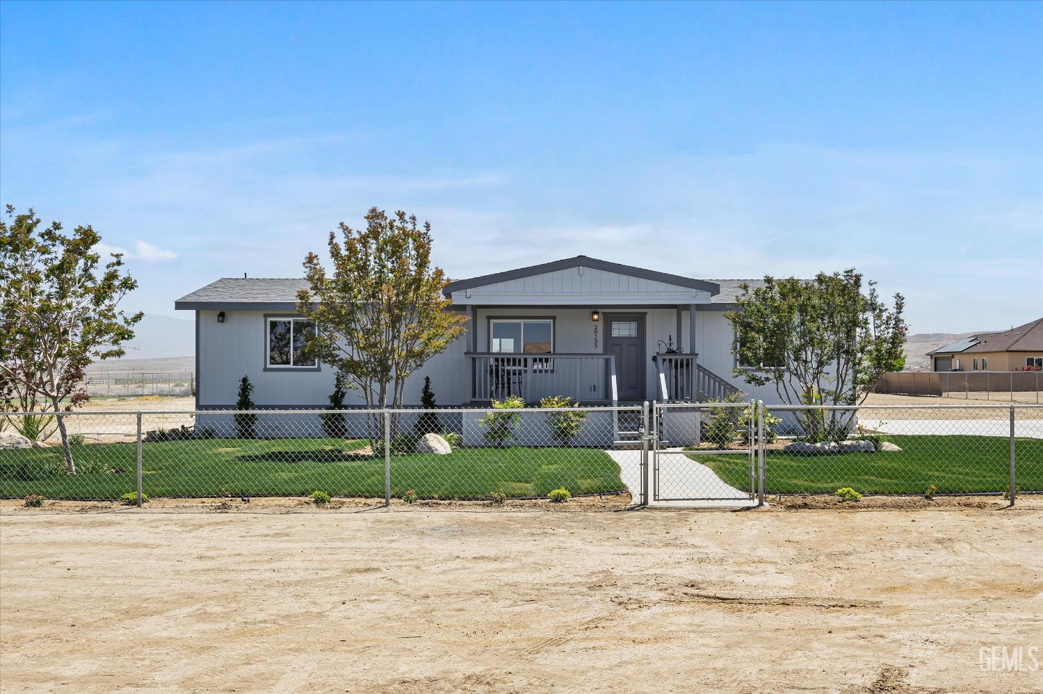 Undisclosed Address Taft, CA 93268 - Photo 11 of 40 a front view of a house with a yard