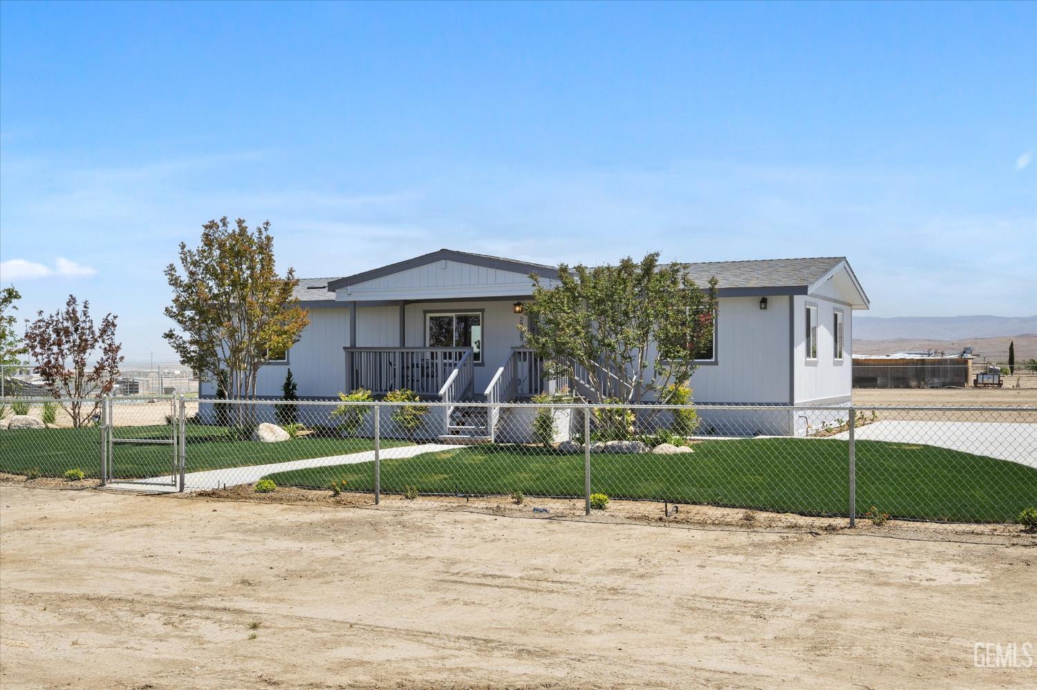 Undisclosed Address Taft, CA 93268 - Photo 12 of 40 a view of a house with backyard and tree s
