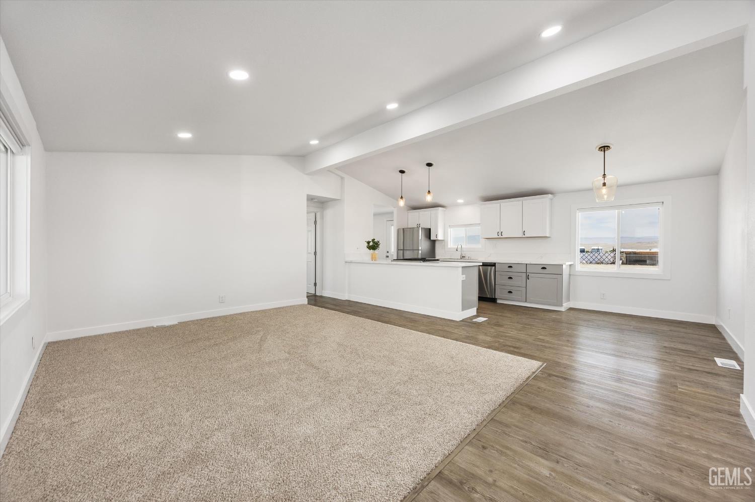 Undisclosed Address Taft, CA 93268 - Photo 15 of 40 a large white kitchen with kitchen island a sink stainless steel appliances and cabinets