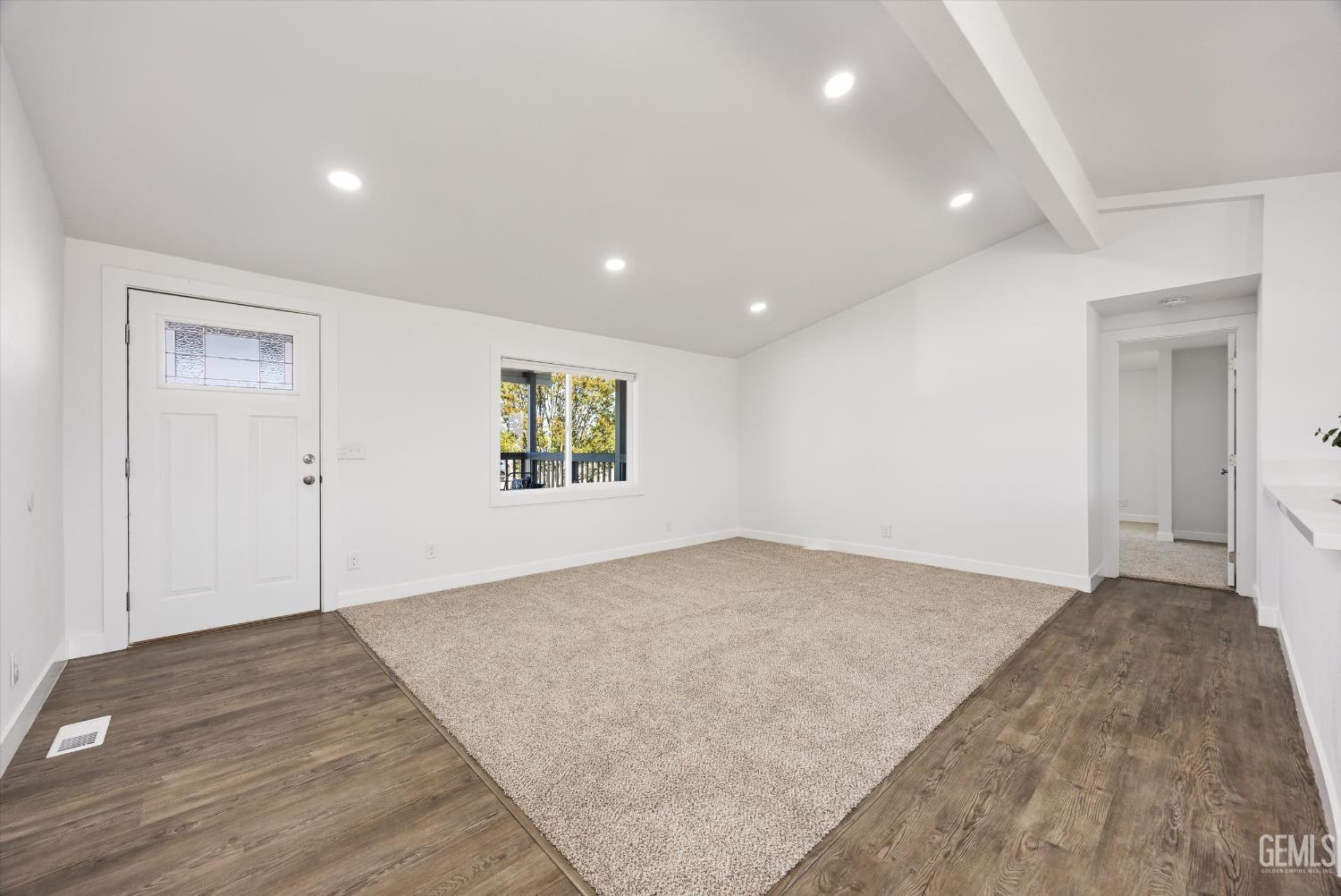 Undisclosed Address Taft, CA 93268 - Photo 16 of 40 an empty room with wooden floor and windows