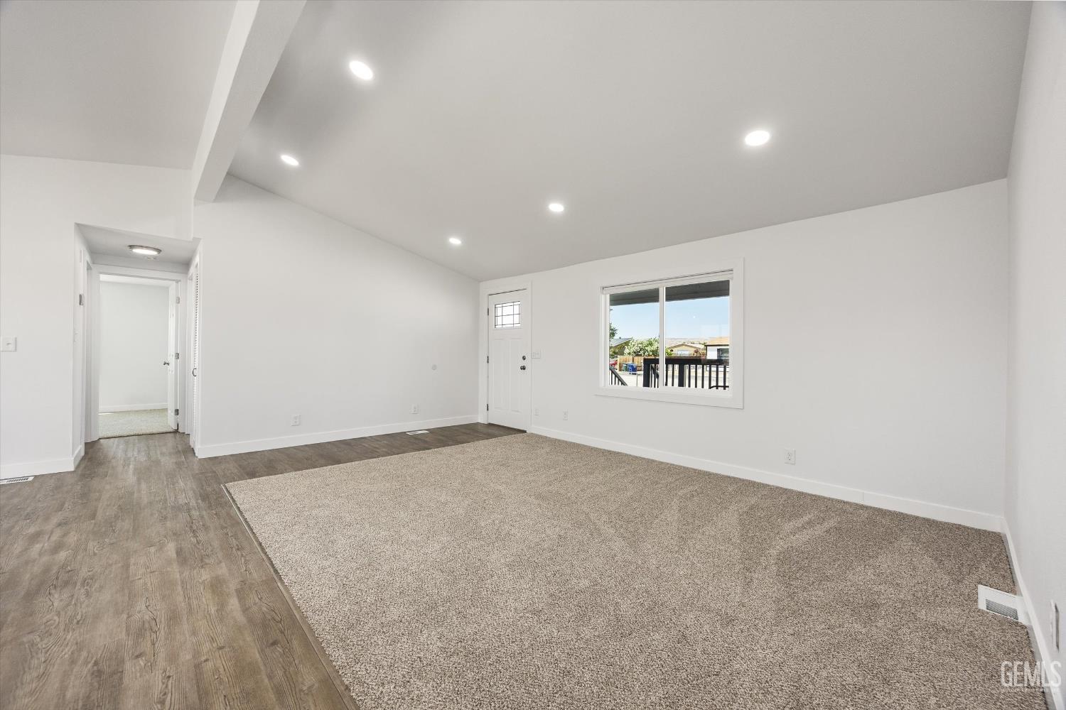 Undisclosed Address Taft, CA 93268 - Photo 18 of 40 an empty room with wooden floor and windows