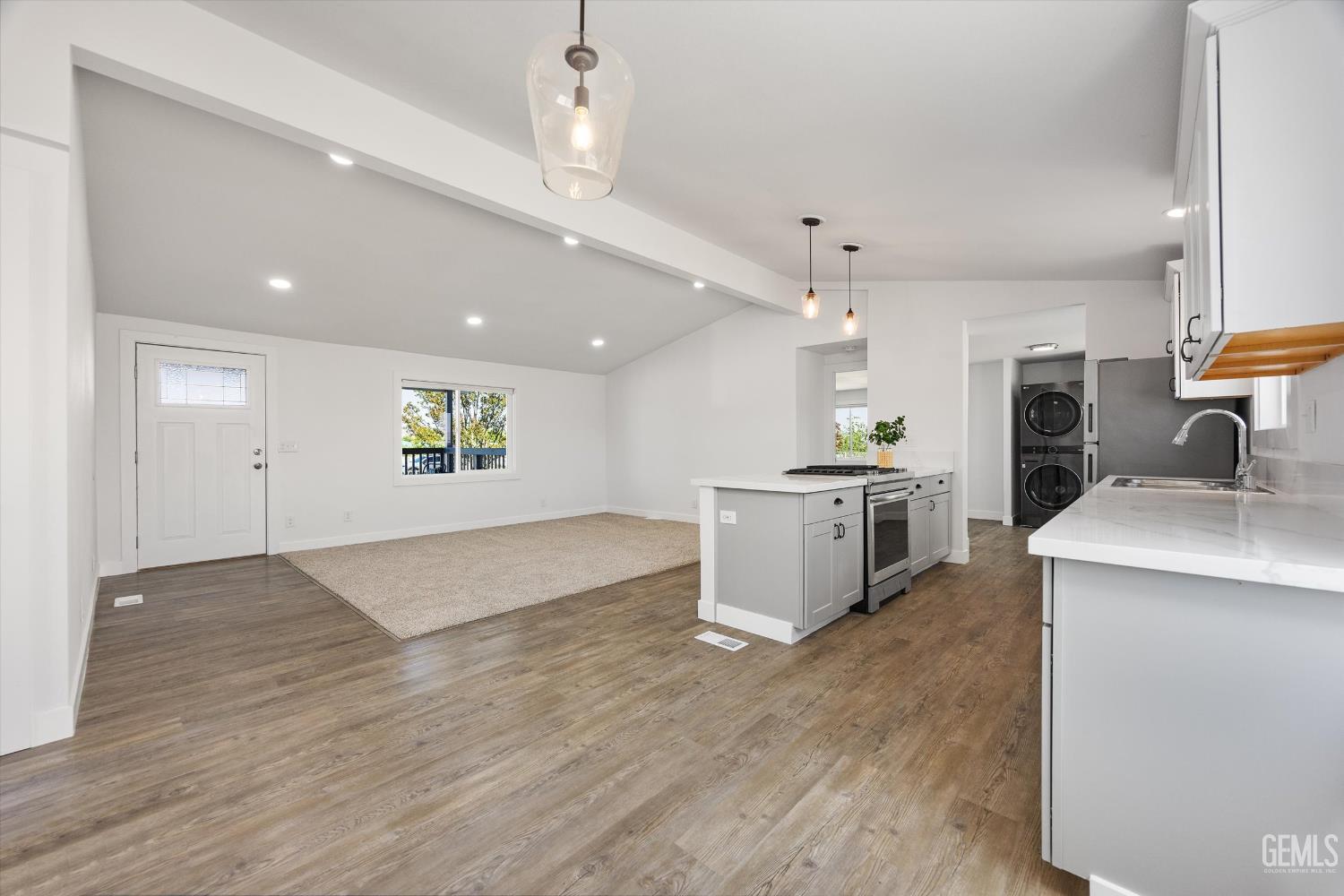 Undisclosed Address Taft, CA 93268 - Photo 21 of 40 a large kitchen with a lot of cabinets and wooden floor
