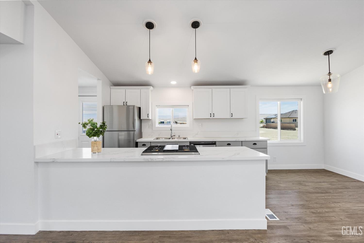 Undisclosed Address Taft, CA 93268 - Photo 22 of 40 a kitchen with kitchen island white cabinets and stainless steel appliances