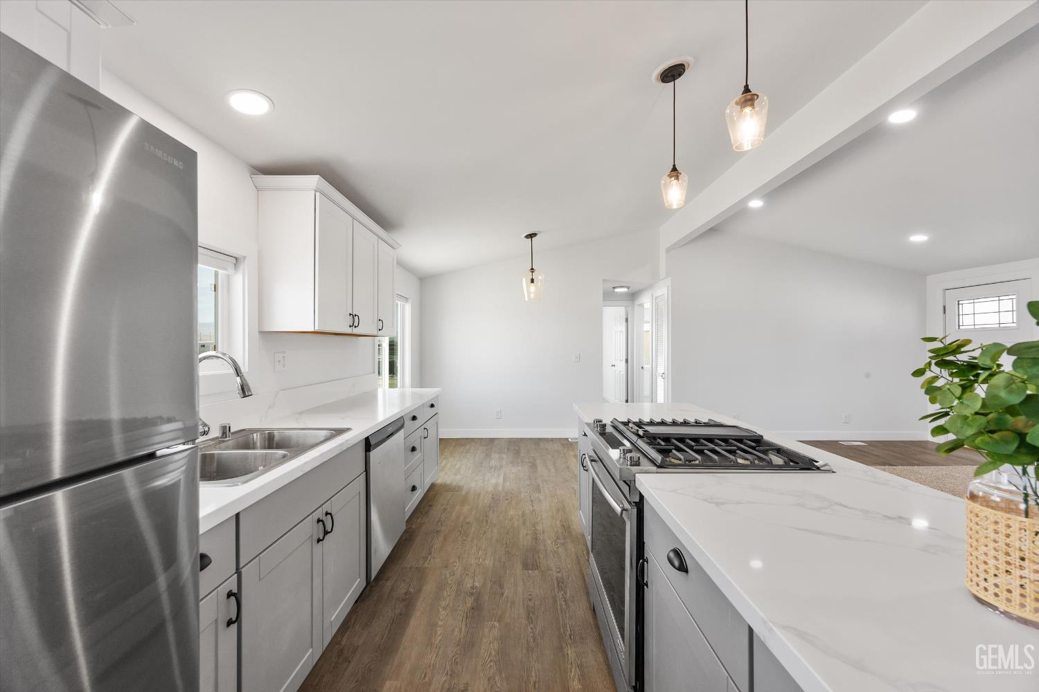 Undisclosed Address Taft, CA 93268 - Photo 25 of 40 a kitchen with sink a refrigerator and a stove