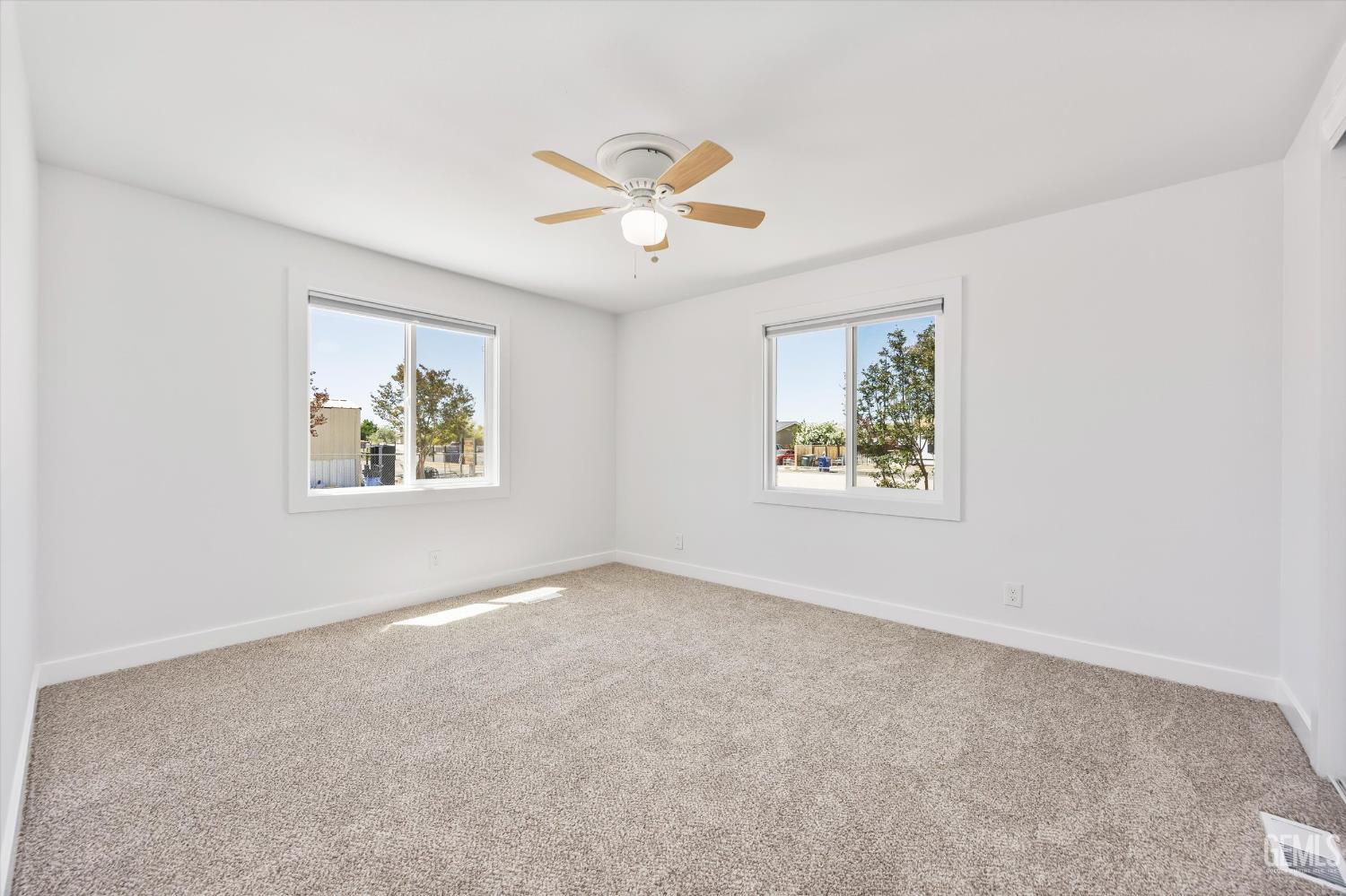Undisclosed Address Taft, CA 93268 - Photo 26 of 40 an empty room with windows and ceiling fan