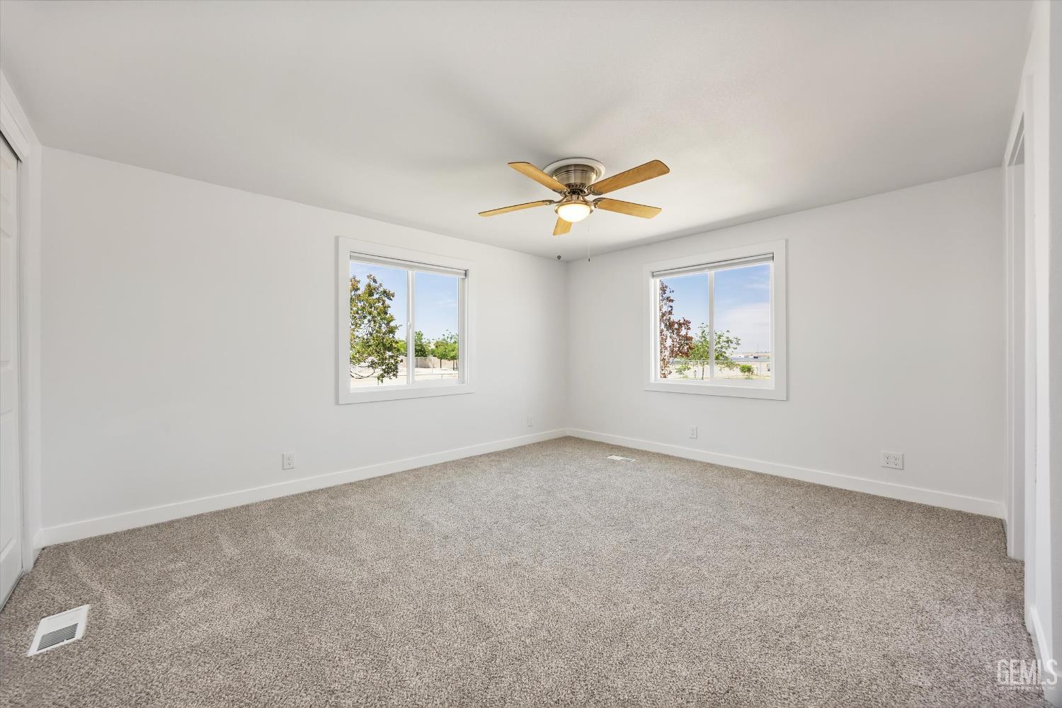 Undisclosed Address Taft, CA 93268 - Photo 29 of 40 an empty room with windows and ceiling fan