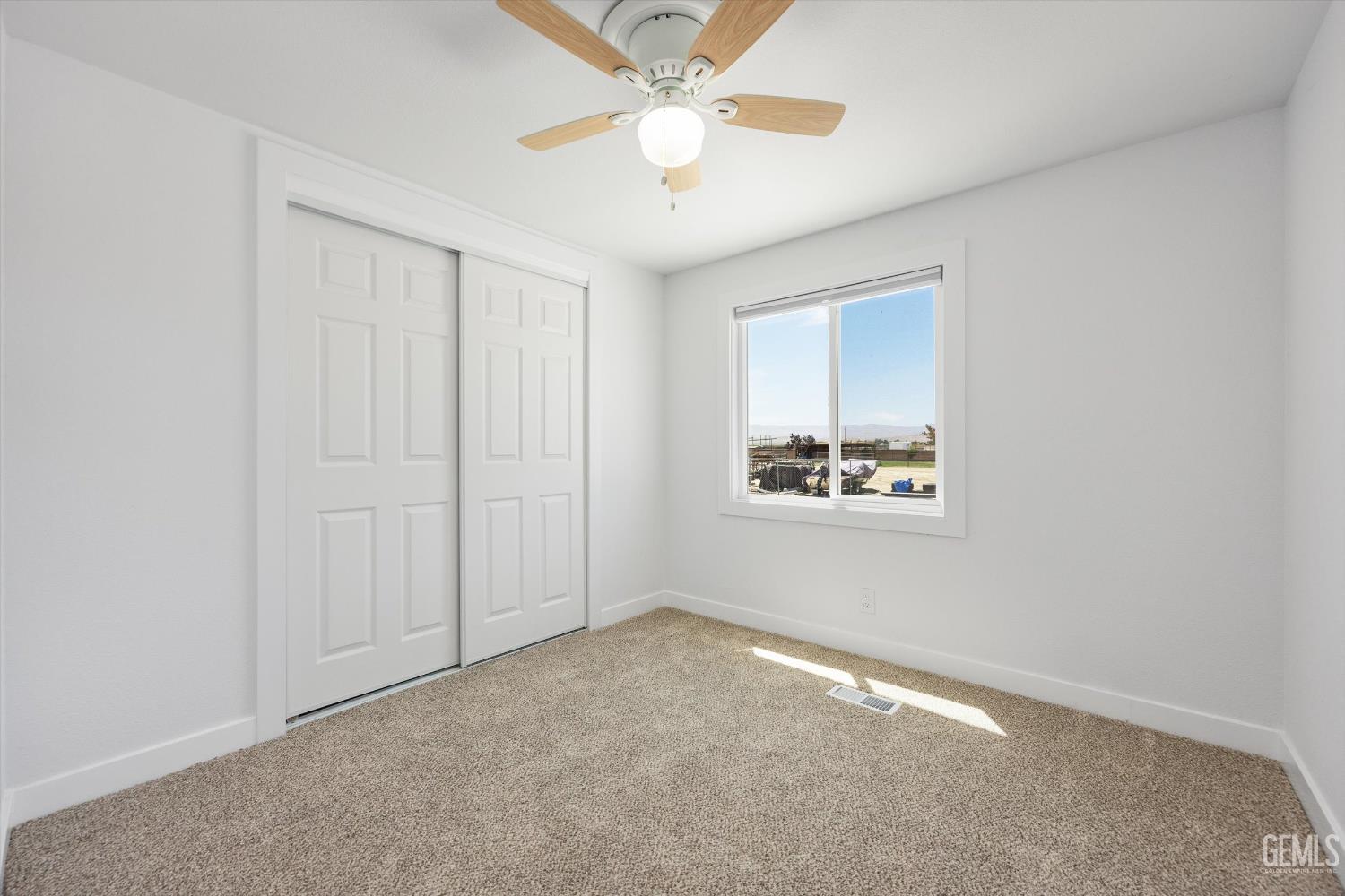 Undisclosed Address Taft, CA 93268 - Photo 32 of 40 an empty room with a window and a ceiling fan