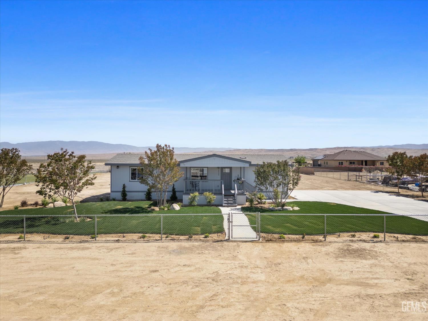 Undisclosed Address Taft, CA 93268 - Photo 4 of 40 a view of a street with a house in the background