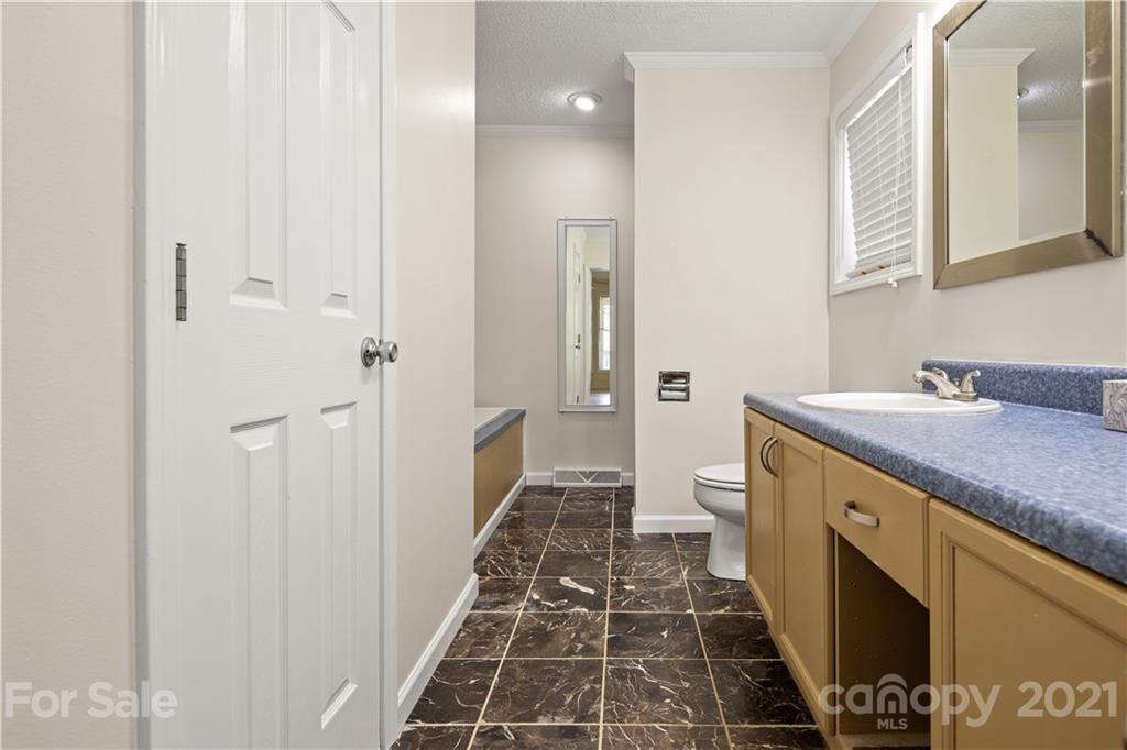 63 Phillipsville Loop Canton, NC 28716 - Photo 14 of 17 a bathroom with a sink and a mirror