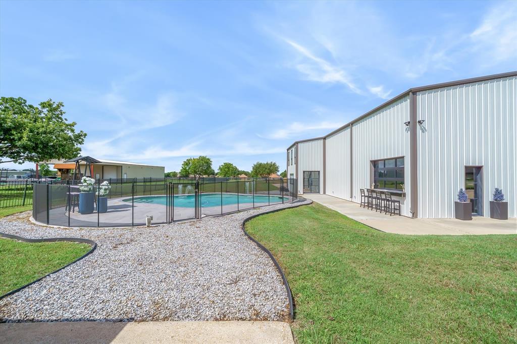 9346 Homestead Lane Forney, TX 75126 - Photo 4 of 39 A beautiful pool with premier safety fencing -- shop has serving bar and pass through window for the perfect pool party!