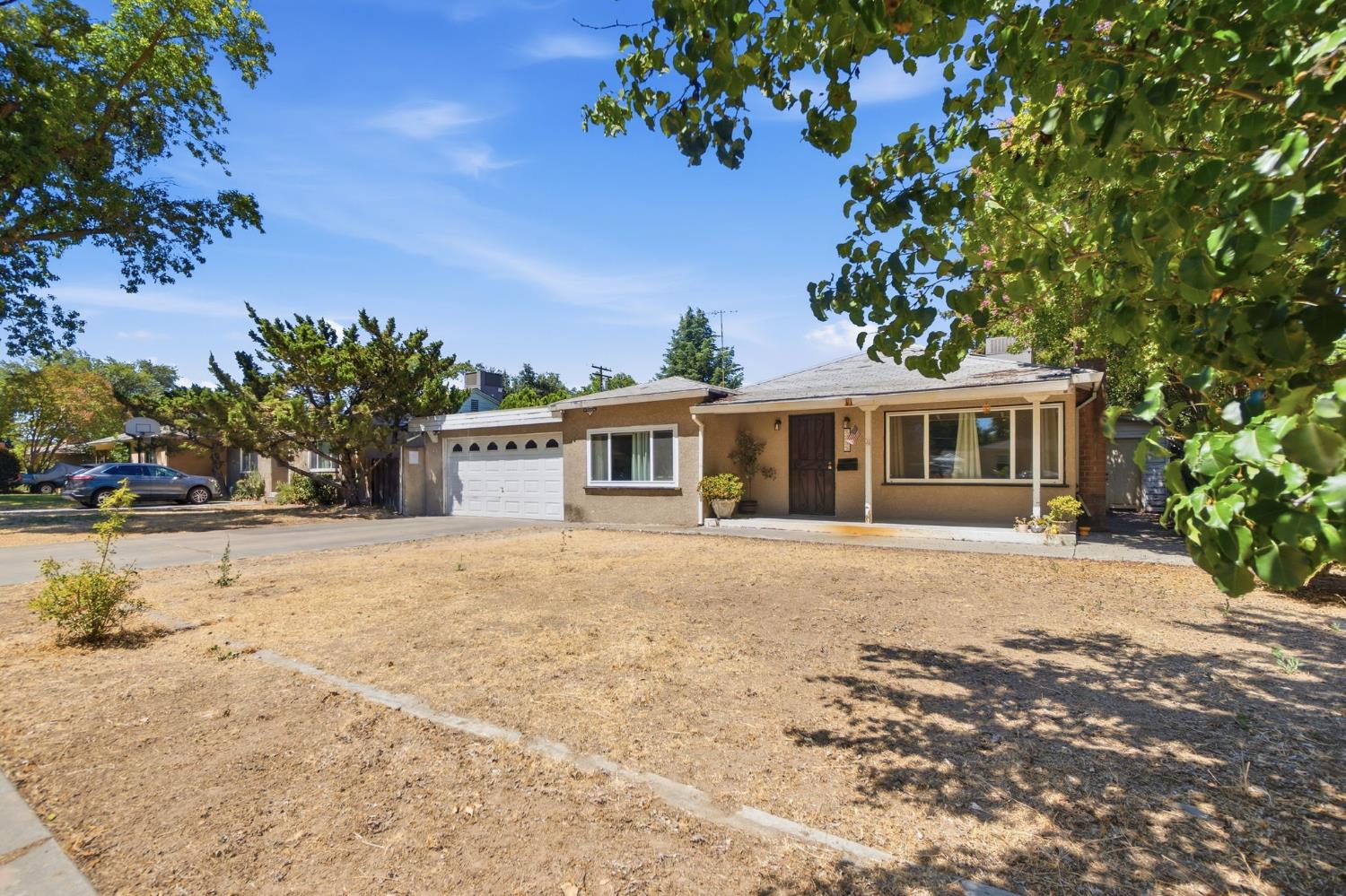 1705 Stetson Avenue Modesto, CA 95350 - Photo 2 of 32 a front view of a house with a yard and garage