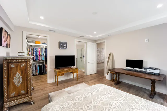 a living room with furniture a piano and a flat screen tv