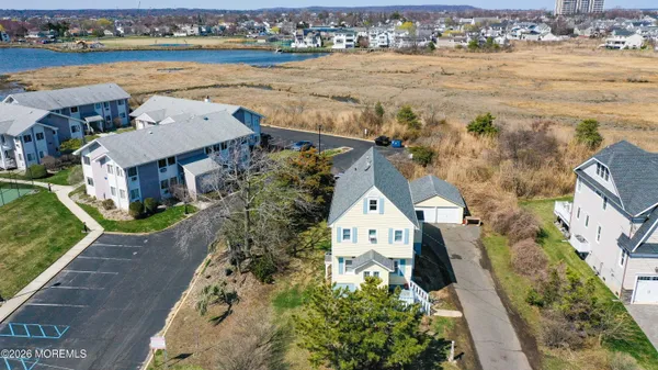 an aerial view of a house with outdoor space and lake view