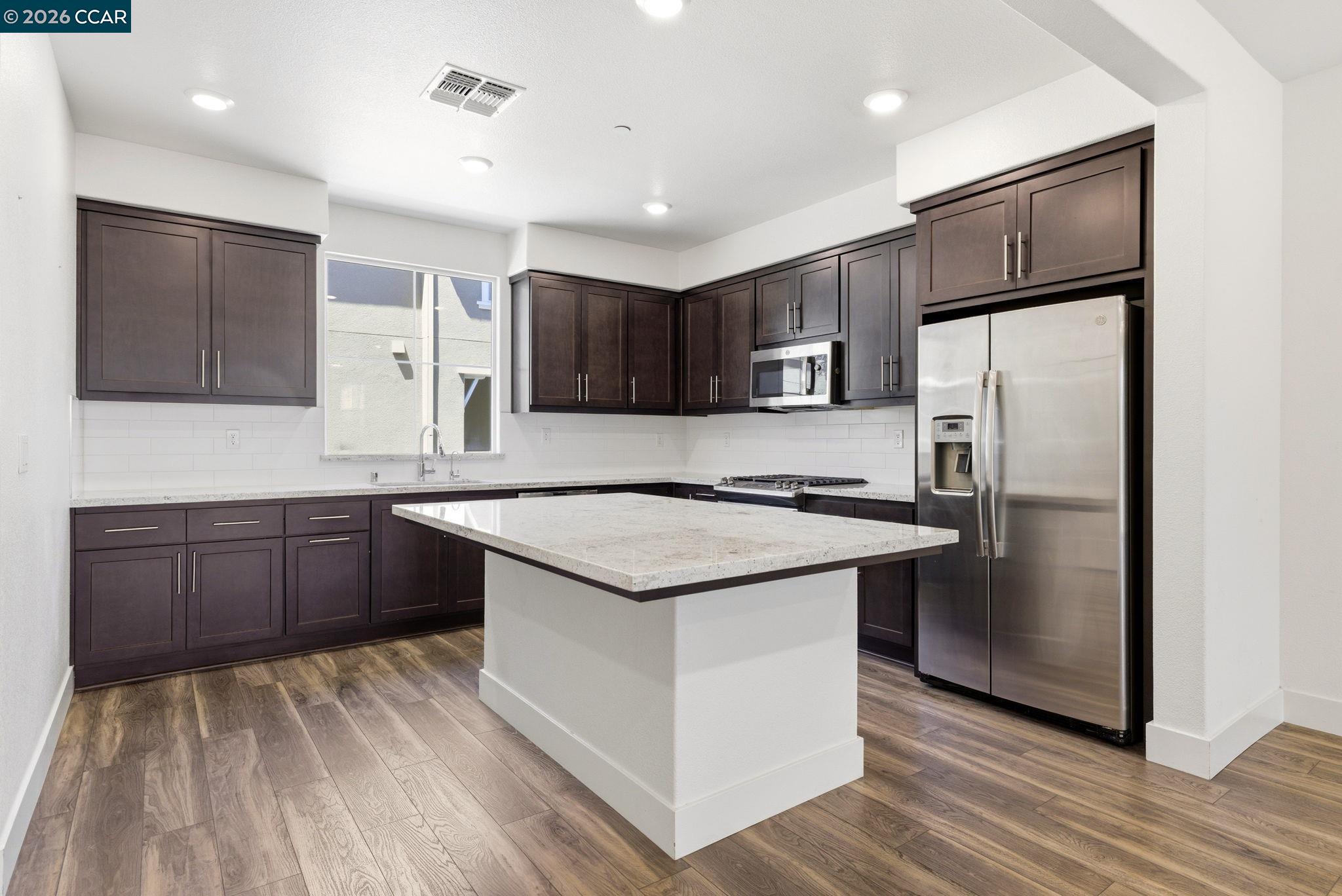 205 Plum Tree Street Livermore, CA 94551 - Photo 17 of 47 a kitchen with stainless steel appliances granite countertop a refrigerator and a stove top oven