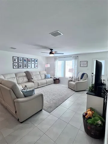 a large bedroom with a bed and a flat screen tv