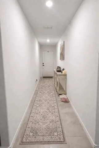 a kitchen with white cabinets and black appliances