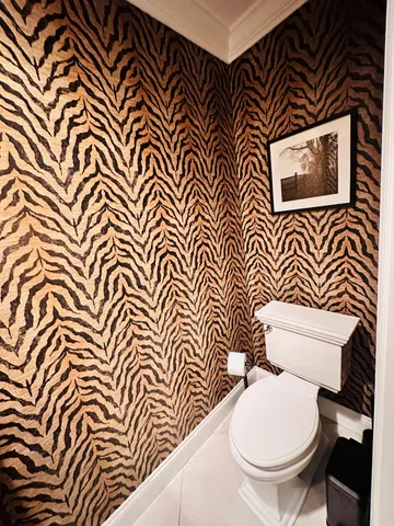 a white toilet sitting next to a shower curtain