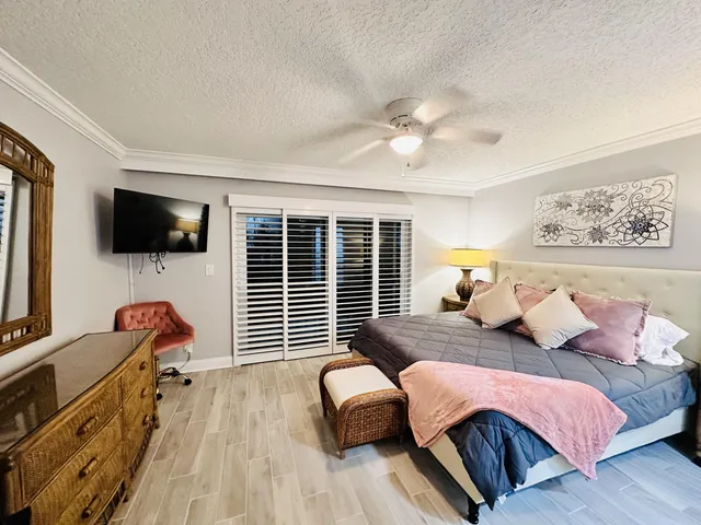 a bedroom with furniture and a flat screen tv