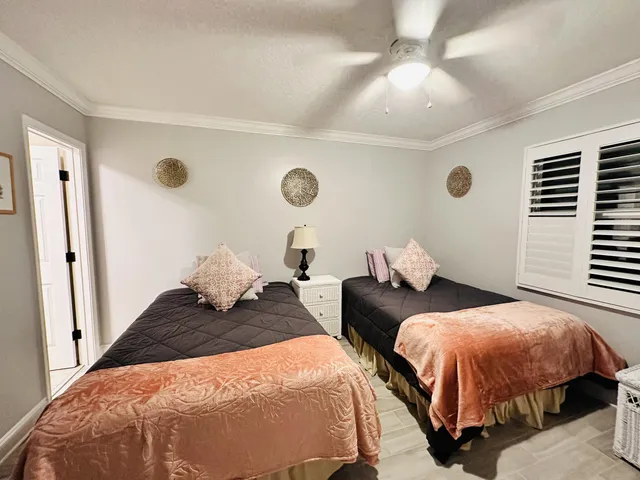 a bedroom with two beds and a chandelier