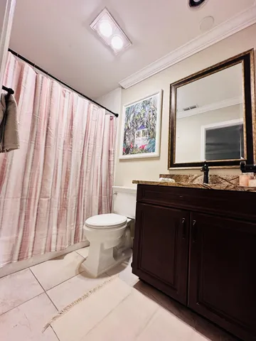 a bathroom with a sink a toilet and mirror