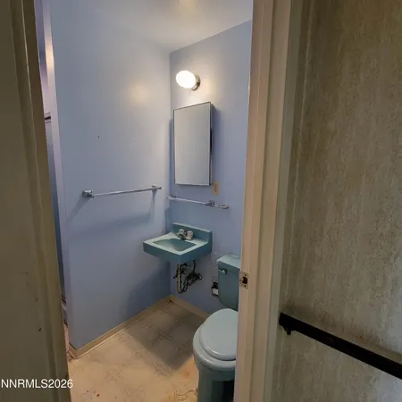 a bathroom with a sink toilet and a mirror