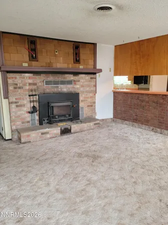 a view of a livingroom with a fireplace and a projector