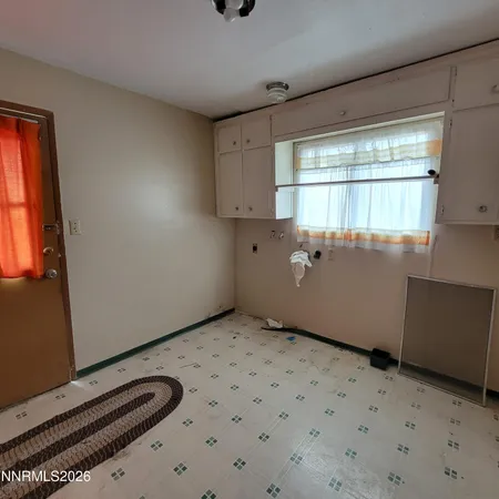 a view of a room with wooden floor and windows